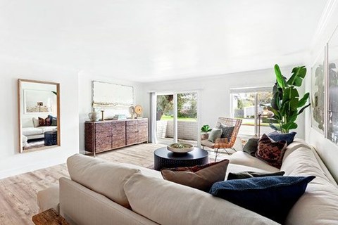A living room with a white couch and a coffee table.